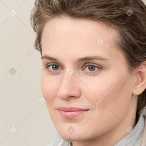 Joyful white young-adult female with short  brown hair and grey eyes