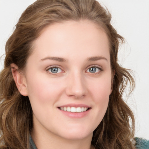 Joyful white young-adult female with long  brown hair and blue eyes