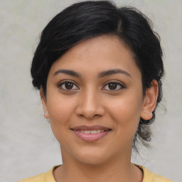 Joyful latino young-adult female with medium  brown hair and brown eyes