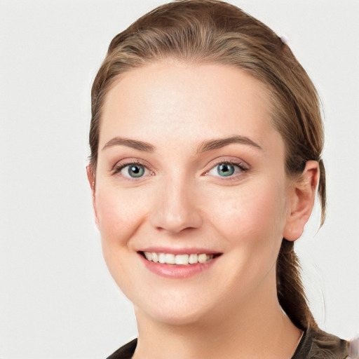 Joyful white young-adult female with long  brown hair and blue eyes