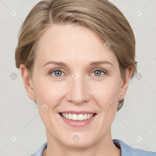 Joyful white adult female with medium  brown hair and grey eyes