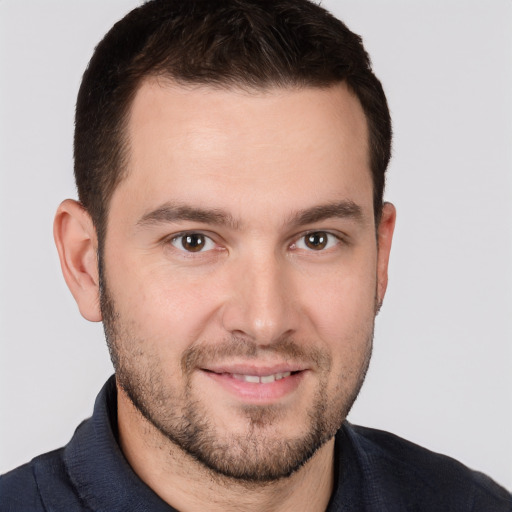 Joyful white young-adult male with short  brown hair and brown eyes