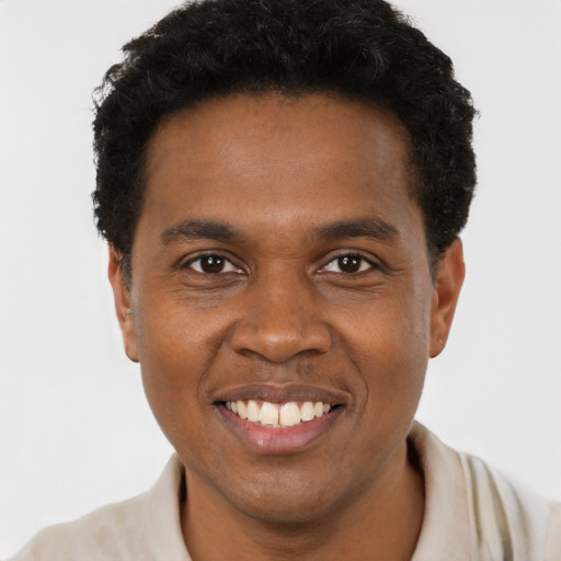 Joyful black young-adult male with short  black hair and brown eyes