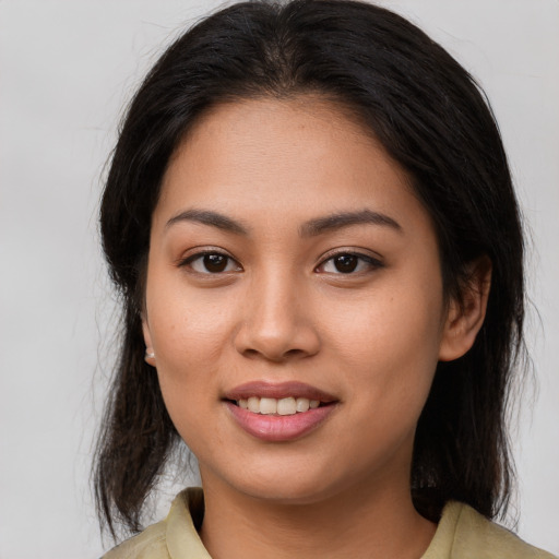 Joyful asian young-adult female with medium  brown hair and brown eyes