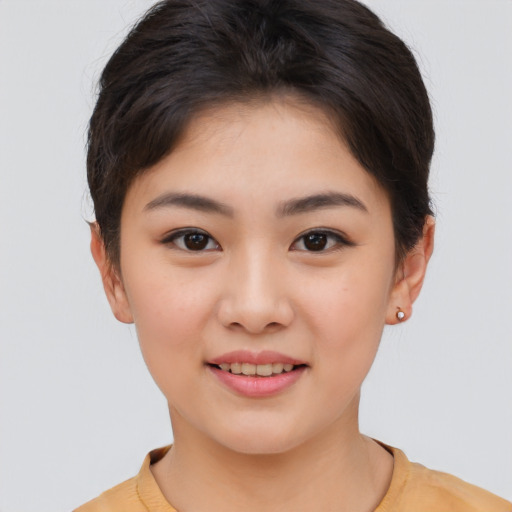 Joyful asian young-adult female with short  brown hair and brown eyes