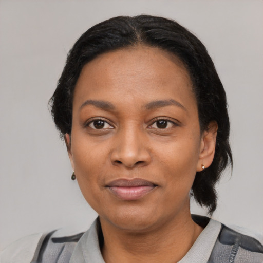 Joyful black young-adult female with medium  black hair and brown eyes