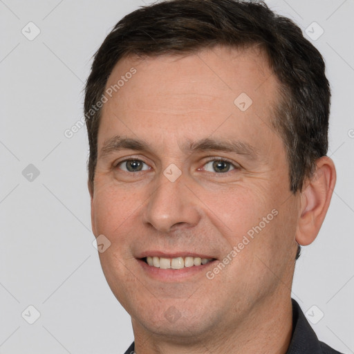 Joyful white adult male with short  brown hair and brown eyes