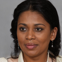 Joyful black young-adult female with medium  brown hair and brown eyes