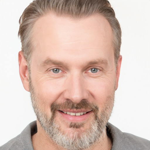 Joyful white adult male with short  brown hair and grey eyes