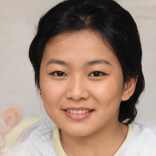 Joyful asian young-adult female with medium  brown hair and brown eyes