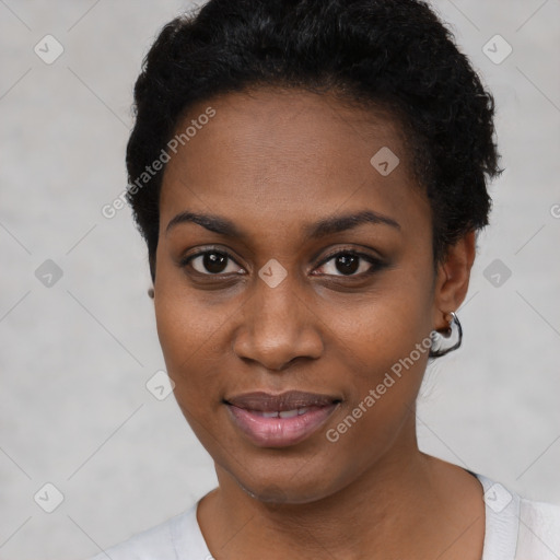 Joyful black young-adult female with short  black hair and brown eyes