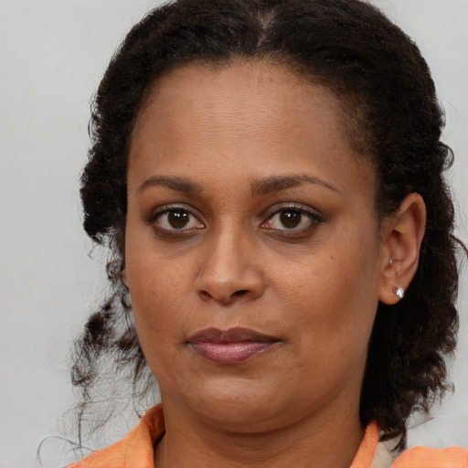 Neutral black young-adult female with medium  brown hair and brown eyes