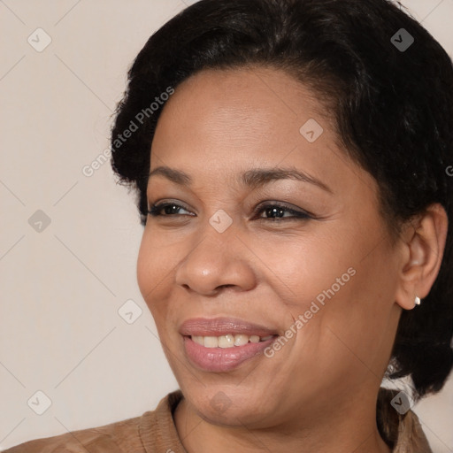 Joyful black young-adult female with medium  brown hair and brown eyes