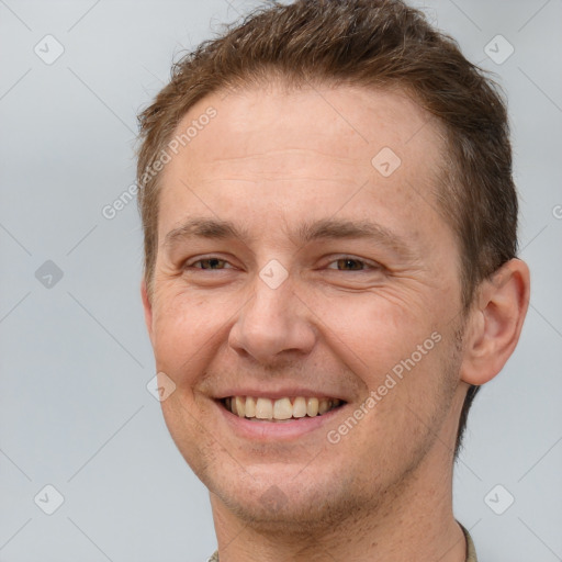 Joyful white adult male with short  brown hair and brown eyes