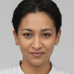 Joyful latino young-adult female with short  brown hair and brown eyes