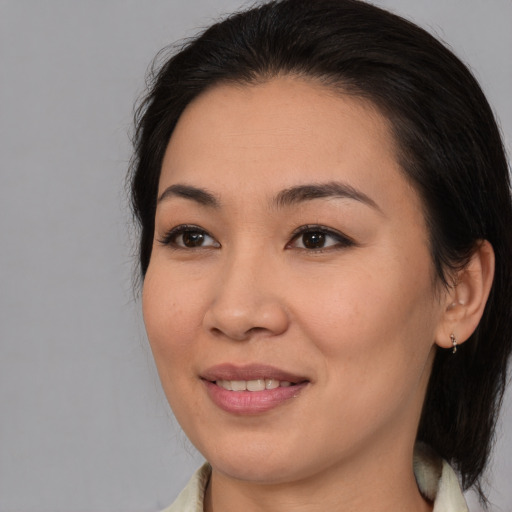 Joyful asian young-adult female with medium  brown hair and brown eyes