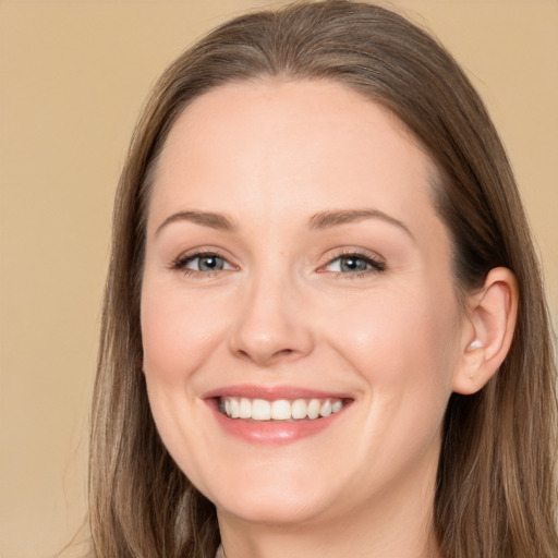 Joyful white adult female with long  brown hair and grey eyes