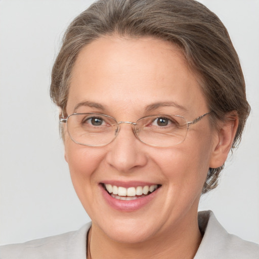 Joyful white adult female with medium  brown hair and grey eyes