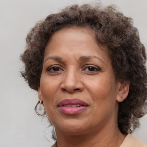 Joyful black adult female with medium  brown hair and brown eyes