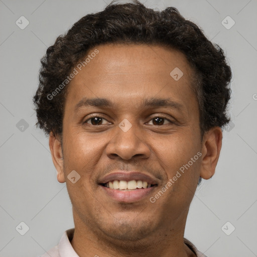 Joyful latino young-adult male with short  brown hair and brown eyes