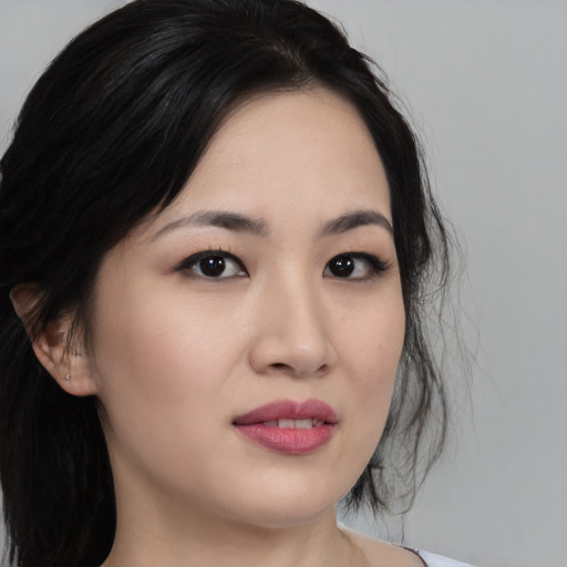 Joyful asian young-adult female with medium  black hair and brown eyes