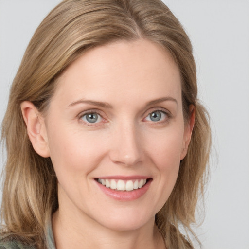 Joyful white young-adult female with medium  brown hair and blue eyes