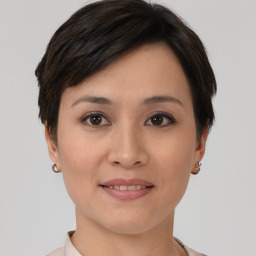 Joyful asian young-adult female with short  brown hair and brown eyes