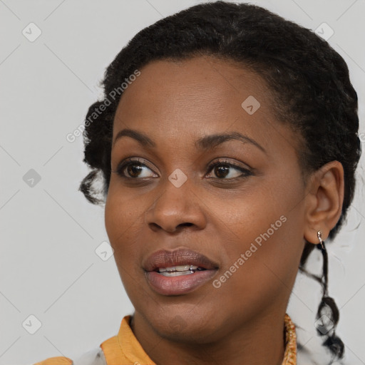 Joyful black young-adult female with short  brown hair and brown eyes