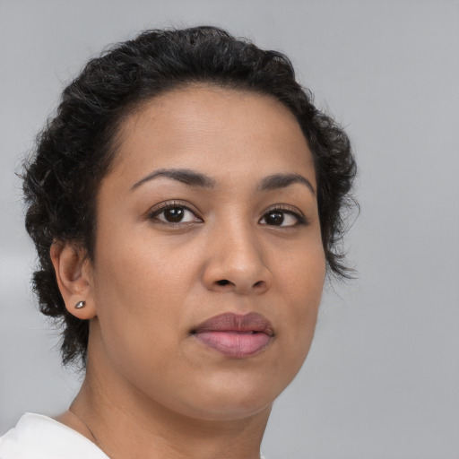 Joyful latino young-adult female with short  brown hair and brown eyes