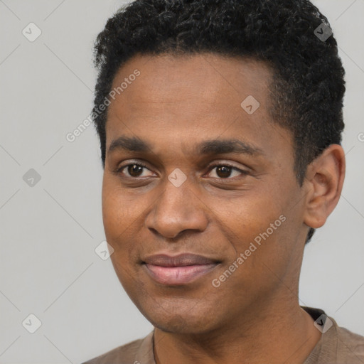 Joyful black young-adult male with short  black hair and brown eyes