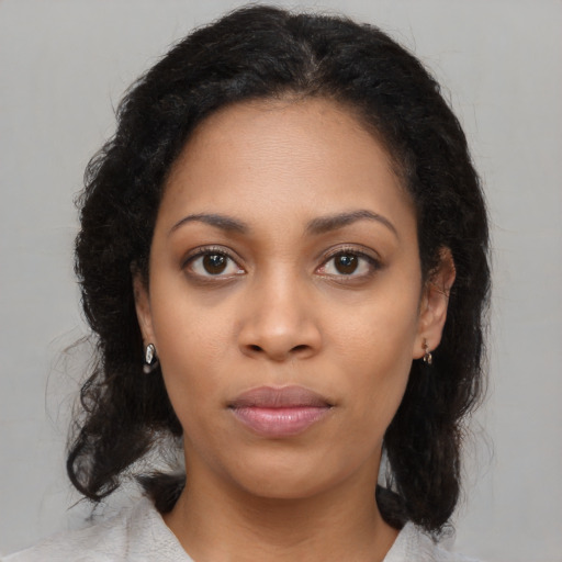 Neutral black young-adult female with medium  brown hair and brown eyes