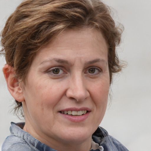 Joyful white adult female with medium  brown hair and grey eyes