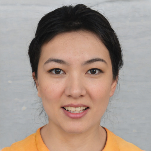 Joyful white young-adult female with short  brown hair and brown eyes