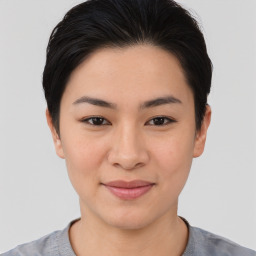 Joyful asian young-adult female with short  brown hair and brown eyes