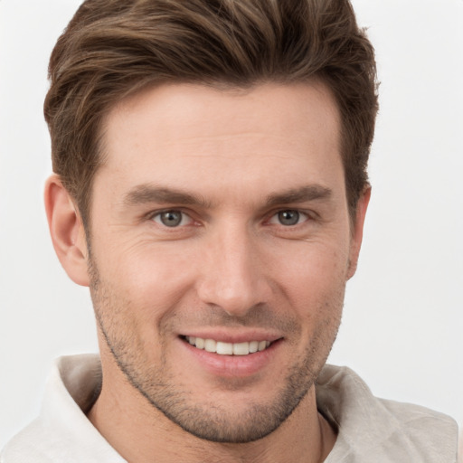 Joyful white young-adult male with short  brown hair and grey eyes