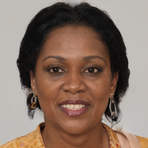Joyful black adult female with medium  brown hair and brown eyes