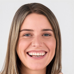 Joyful white young-adult female with long  brown hair and green eyes