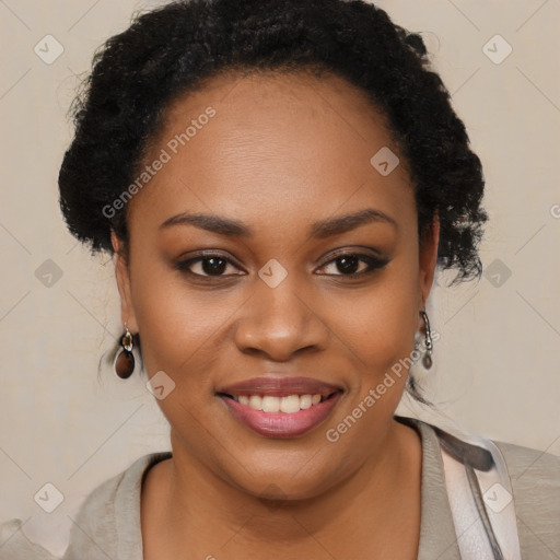 Joyful black young-adult female with long  black hair and brown eyes