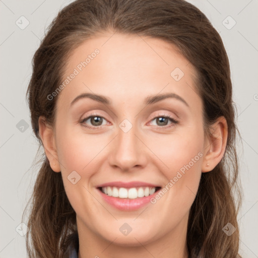 Joyful white young-adult female with long  brown hair and green eyes