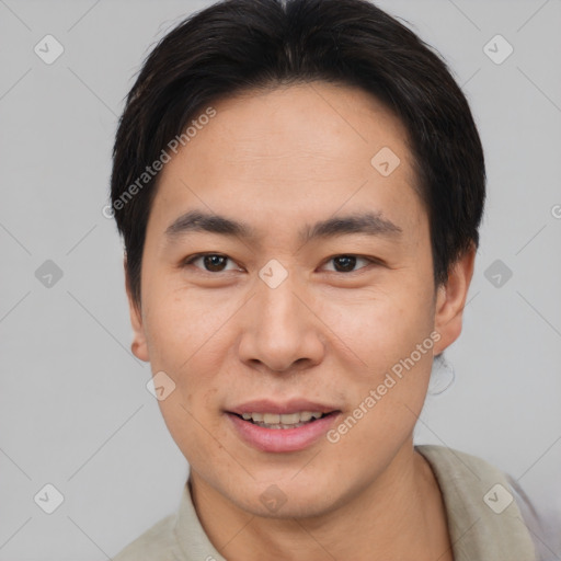 Joyful asian young-adult male with short  brown hair and brown eyes