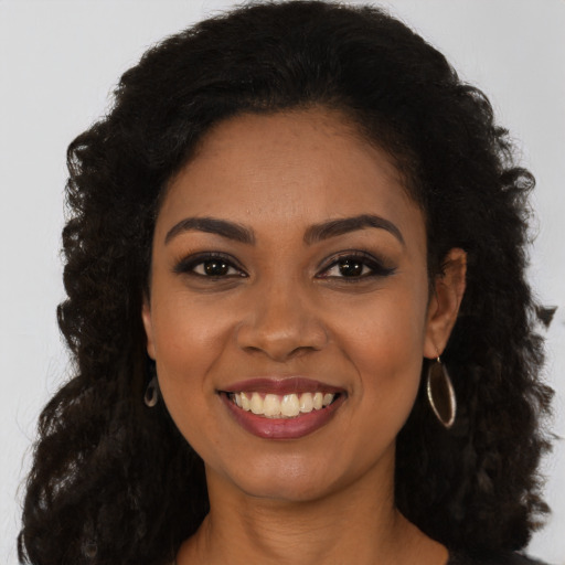 Joyful latino young-adult female with long  black hair and brown eyes