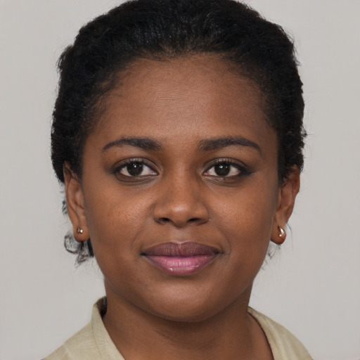 Joyful black young-adult female with short  brown hair and brown eyes