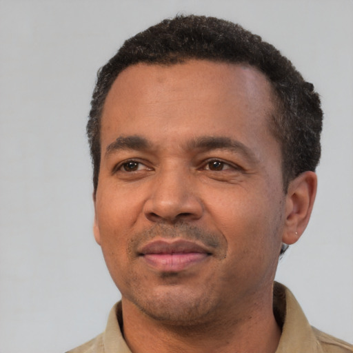 Joyful latino young-adult male with short  brown hair and brown eyes