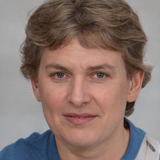 Joyful white adult female with medium  brown hair and blue eyes