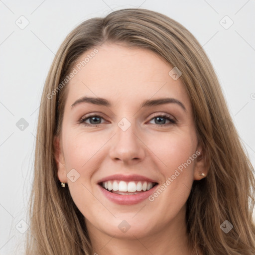 Joyful white young-adult female with long  brown hair and grey eyes