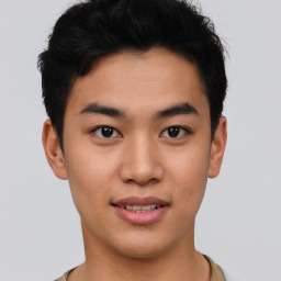 Joyful asian young-adult male with short  black hair and brown eyes