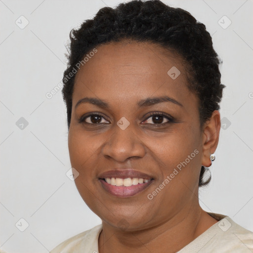 Joyful black young-adult female with short  brown hair and brown eyes