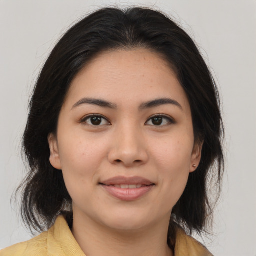 Joyful asian young-adult female with medium  brown hair and brown eyes