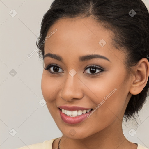 Joyful latino young-adult female with long  brown hair and brown eyes