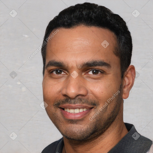 Joyful white young-adult male with short  black hair and brown eyes